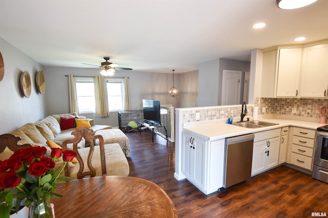 1825 Holiday Dr, Pekin, IL 61554 - kitchen featuring appliances with stainless steel finishes, open floor plan, a peninsula, light countertops, and decorative backsplash