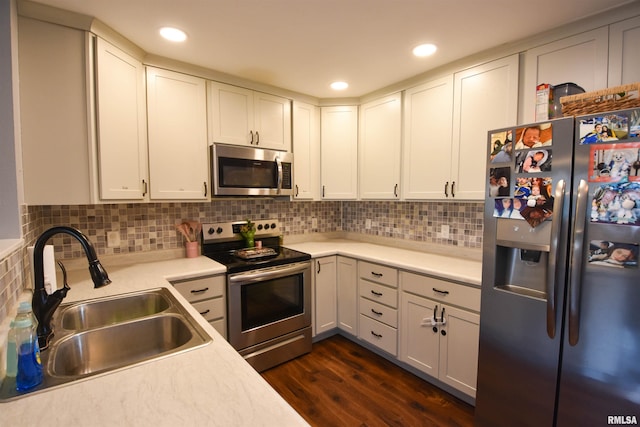 1825 Holiday Dr, Pekin, IL 61554 - kitchen featuring appliances with stainless steel finishes, dark wood-style flooring, light countertops, white cabinets, and recessed lighting