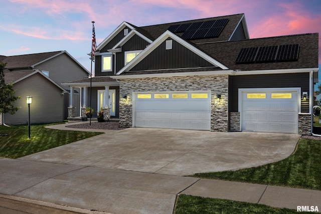2821 W Lake Trail Ct, Dunlap, IL 61525 - craftsman house featuring board and batten siding, stone siding, concrete driveway, solar panels, and an attached garage