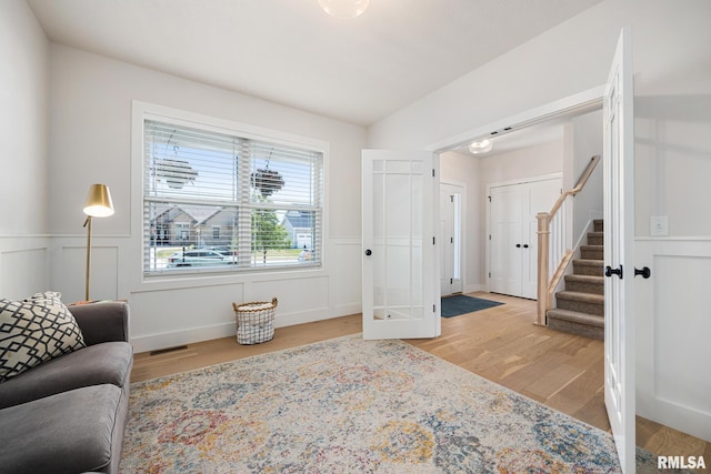 2821 W Lake Trail Ct, Dunlap, IL 61525 - living area featuring light wood-type flooring, a wainscoted wall, and stairs