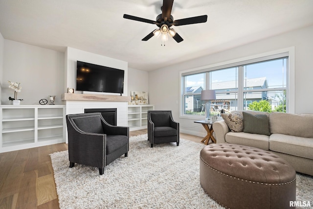 2821 W Lake Trail Ct, Dunlap, IL 61525 - living area featuring wood finished floors, ceiling fan, and a fireplace