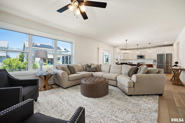 2821 W Lake Trail Ct, Dunlap, IL 61525 - living room featuring light wood-style flooring and a ceiling fan