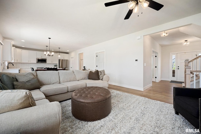 2821 W Lake Trail Ct, Dunlap, IL 61525 - living area featuring ceiling fan, light wood-type flooring, recessed lighting, and a chandelier