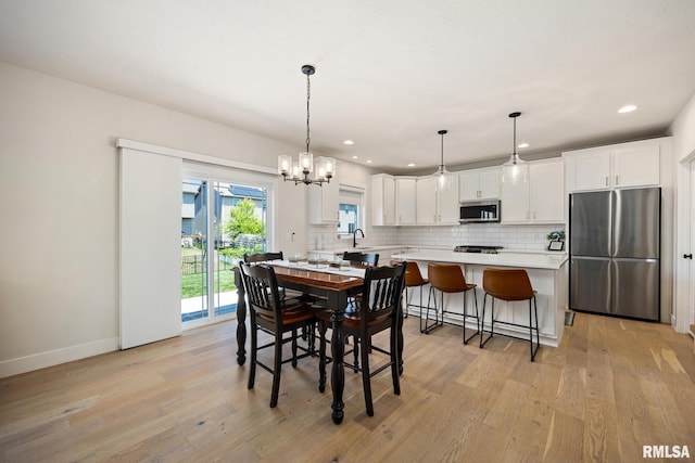 2821 W Lake Trail Ct, Dunlap, IL 61525 - dining space featuring light wood finished floors, recessed lighting, and a chandelier