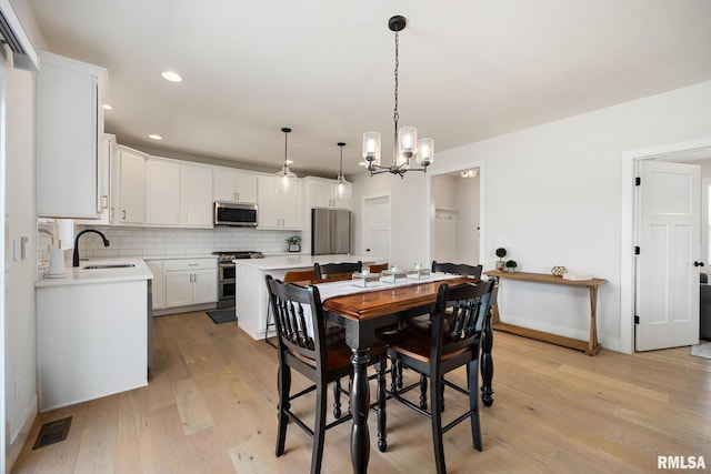 2821 W Lake Trail Ct, Dunlap, IL 61525 - dining area featuring light wood finished floors, a chandelier, and recessed lighting