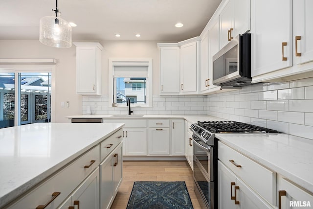 2821 W Lake Trail Ct, Dunlap, IL 61525 - kitchen with appliances with stainless steel finishes, white cabinets, recessed lighting, light wood-style flooring, and backsplash