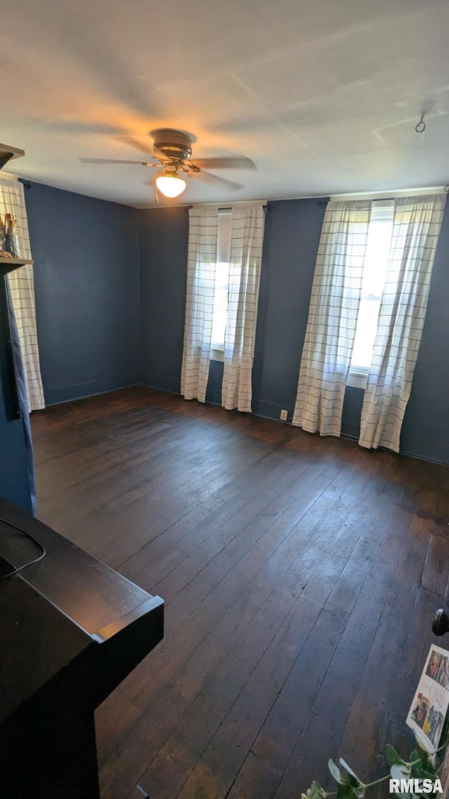 1469 2100th St, Lincoln, IL 62656 - unfurnished living room featuring plenty of natural light, a ceiling fan, and dark wood finished floors
