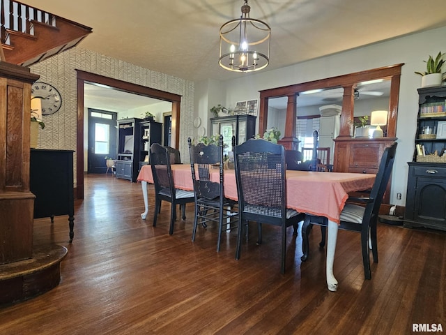 1469 2100th St, Lincoln, IL 62656 - dining room featuring a chandelier, dark wood finished floors, ornate columns, and wallpapered walls
