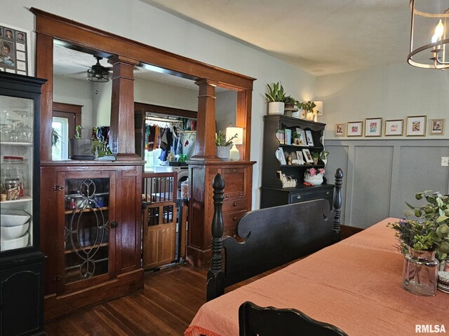 1469 2100th St, Lincoln, IL 62656 - dining area with dark wood finished floors, ornate columns, a wainscoted wall, a chandelier, and a decorative wall
