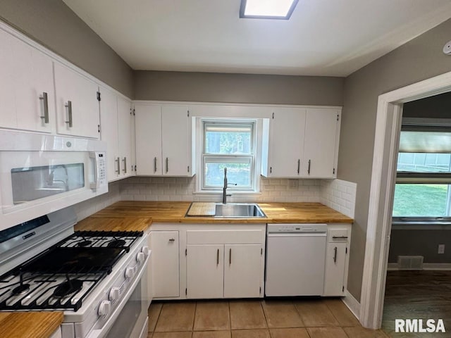 4107 N Hollyridge Cir, Peoria, IL 61614 - kitchen with white appliances, tasteful backsplash, white cabinets, butcher block countertops, and light tile patterned floors