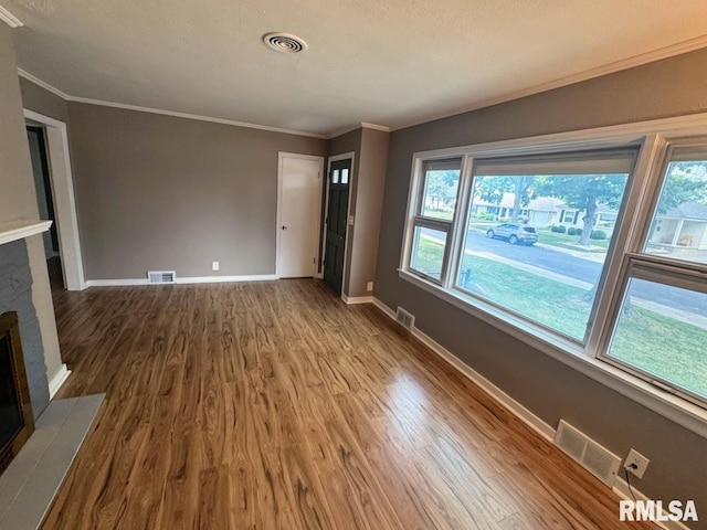 4107 N Hollyridge Cir, Peoria, IL 61614 - unfurnished living room featuring wood finished floors, crown molding, and a fireplace with flush hearth