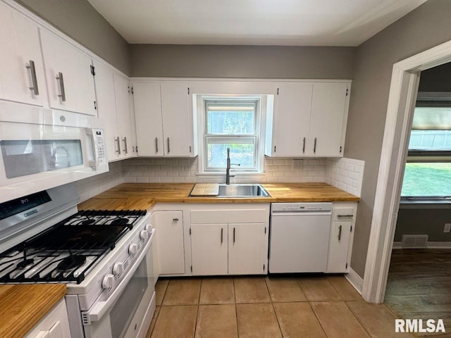 4107 N Hollyridge Cir, Peoria, IL 61614 - kitchen with white appliances, butcher block counters, plenty of natural light, and tasteful backsplash