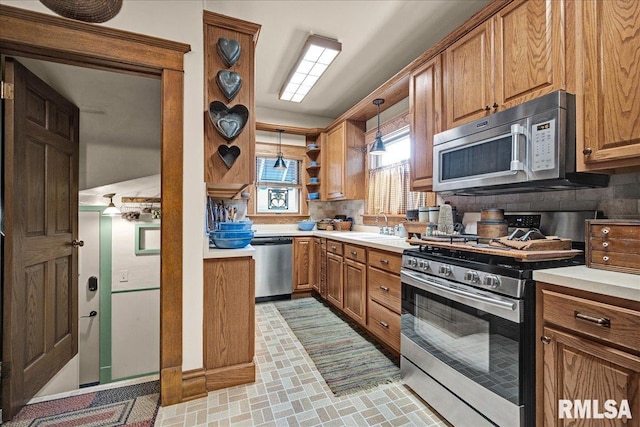 213 S Hanover St, Metamora, IL 61548 - kitchen with stainless steel appliances, brown cabinets, and tasteful backsplash