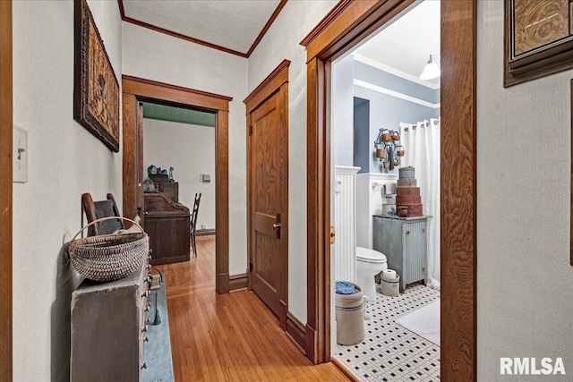 213 S Hanover St, Metamora, IL 61548 - hallway with ornamental molding and light wood-style flooring