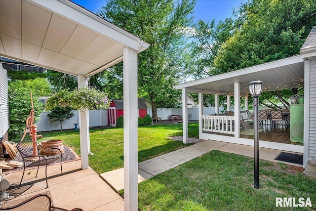 213 S Hanover St, Metamora, IL 61548 - fenced backyard featuring a patio area and a storage unit