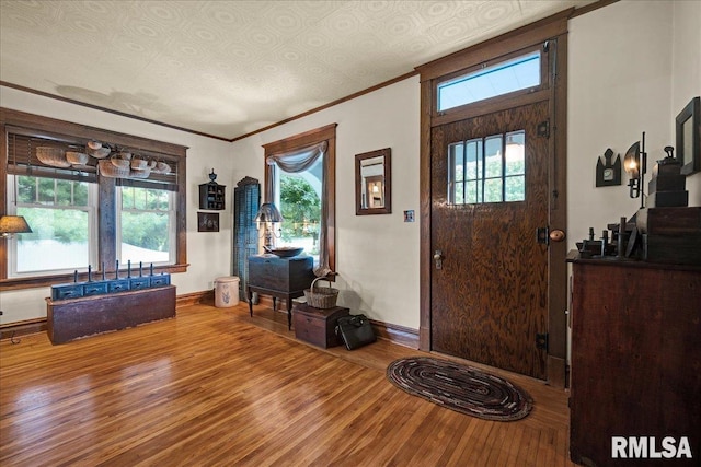 213 S Hanover St, Metamora, IL 61548 - foyer entrance featuring wood finished floors, healthy amount of natural light, and ornamental molding