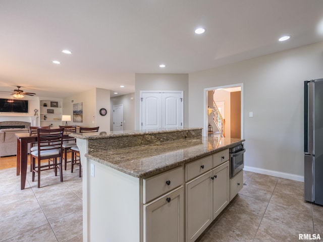 11014 N Saddlehorn Way, Dunlap, IL 61525 - kitchen with appliances with stainless steel finishes, ceiling fan, recessed lighting, light tile patterned flooring, and light stone counters