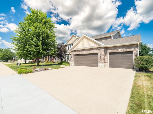11014 N Saddlehorn Way, Dunlap, IL 61525 - craftsman inspired home with brick siding, an attached garage, driveway, a front lawn, and roof with shingles