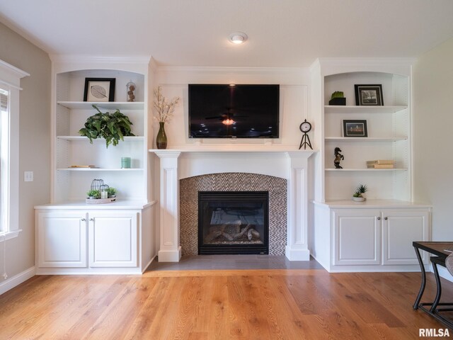 11014 N Saddlehorn Way, Dunlap, IL 61525 - living area featuring light wood finished floors, a tile fireplace, and built in features