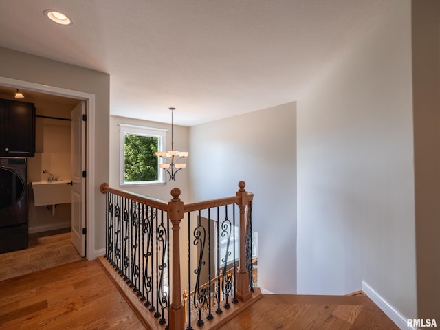 11014 N Saddlehorn Way, Dunlap, IL 61525 - stairway with washer / dryer, wood finished floors, recessed lighting, and a chandelier