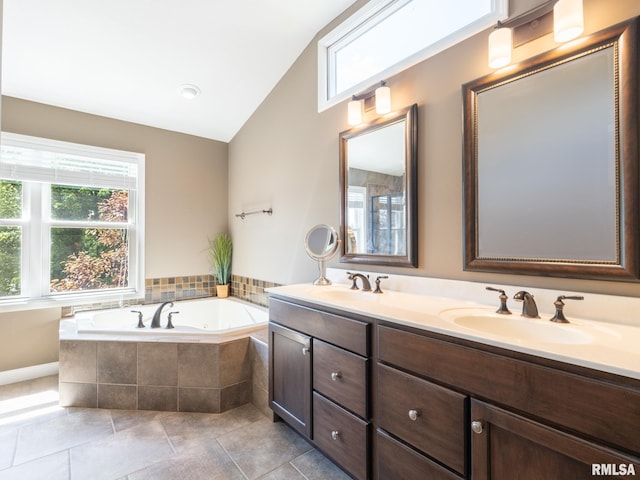 11014 N Saddlehorn Way, Dunlap, IL 61525 - bathroom with double vanity, a garden tub, lofted ceiling, and tile patterned floors
