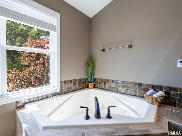 11014 N Saddlehorn Way, Dunlap, IL 61525 - bathroom with plenty of natural light, a whirlpool tub, and lofted ceiling