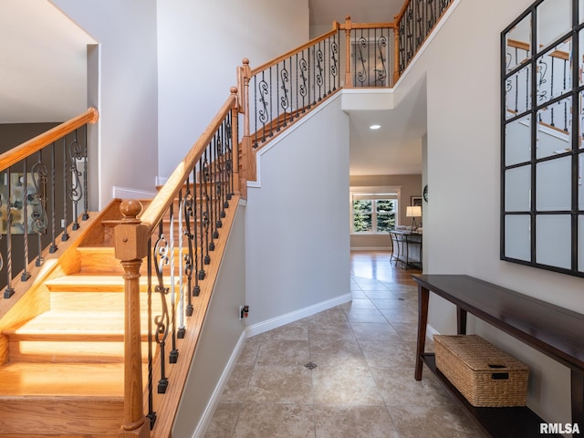 11014 N Saddlehorn Way, Dunlap, IL 61525 - stairway with baseboards and a towering ceiling