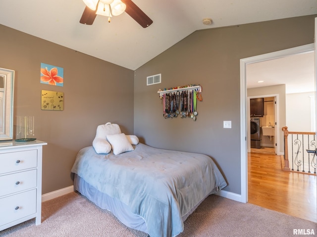 11014 N Saddlehorn Way, Dunlap, IL 61525 - bedroom with vaulted ceiling, light colored carpet, washer / clothes dryer, and ceiling fan