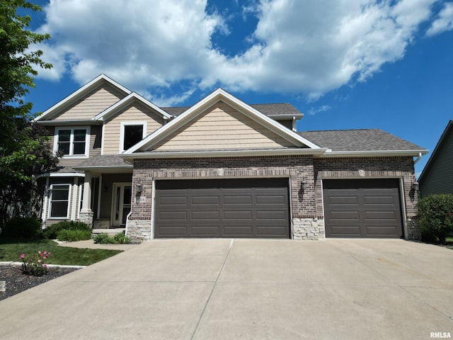 11014 N Saddlehorn Way, Dunlap, IL 61525 - craftsman-style house featuring a garage, driveway, a shingled roof, stone siding, and brick siding