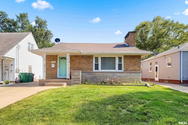 2400 W Callender Ave, West Peoria, IL 61610 - view of front of house featuring a chimney, a front yard, brick siding, and covered porch
