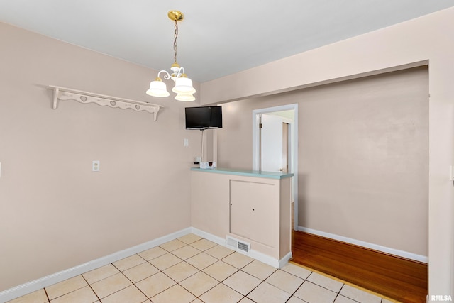 2400 W Callender Ave, West Peoria, IL 61610 - unfurnished room featuring a chandelier and light tile patterned floors