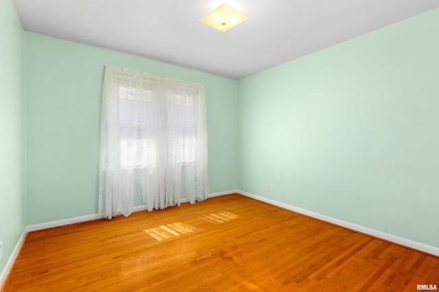 2400 W Callender Ave, West Peoria, IL 61610 - unfurnished room with wood finished floors and baseboards