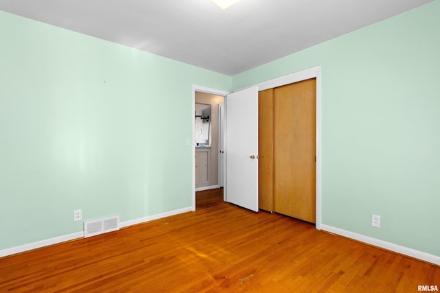 2400 W Callender Ave, West Peoria, IL 61610 - unfurnished bedroom with wood finished floors and a closet