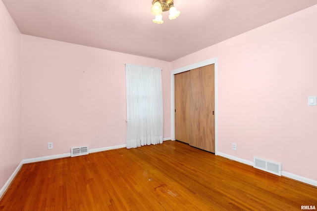 2400 W Callender Ave, West Peoria, IL 61610 - unfurnished bedroom with baseboards and wood finished floors