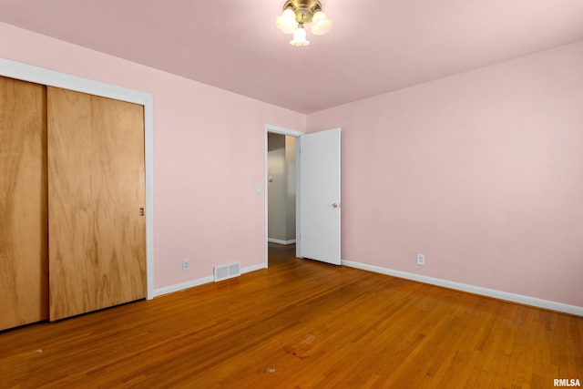2400 W Callender Ave, West Peoria, IL 61610 - unfurnished bedroom featuring wood finished floors and a closet