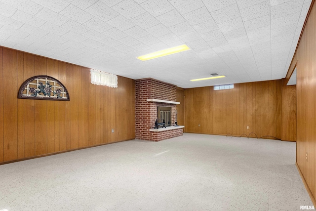 2400 W Callender Ave, West Peoria, IL 61610 - unfurnished living room with wooden walls and a brick fireplace