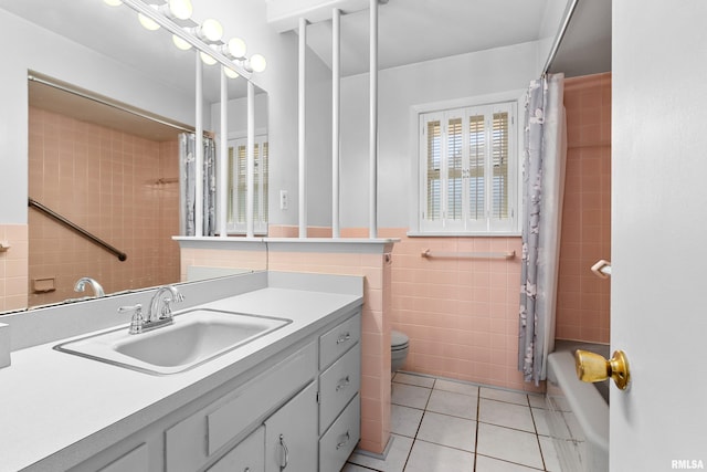 2400 W Callender Ave, West Peoria, IL 61610 - bathroom featuring tile walls, tile patterned floors, vanity, and shower / tub combo with curtain