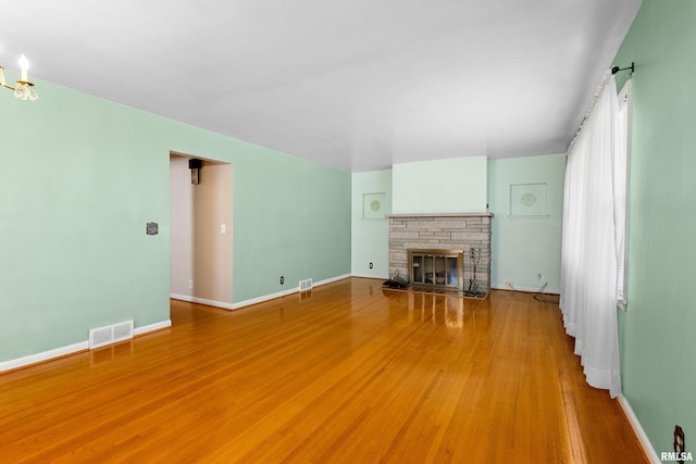 2400 W Callender Ave, West Peoria, IL 61610 - unfurnished living room with light wood-type flooring and a glass covered fireplace