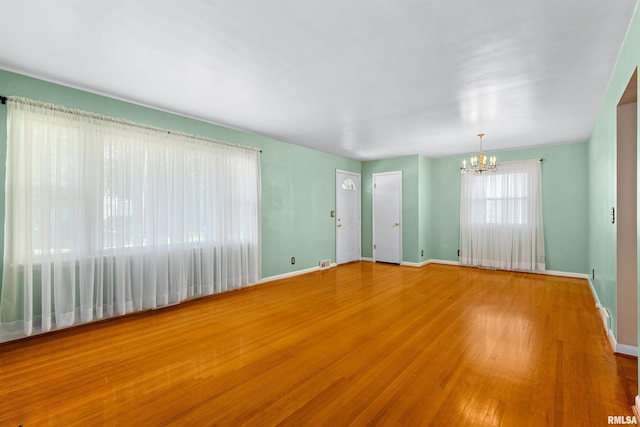 2400 W Callender Ave, West Peoria, IL 61610 - unfurnished living room featuring a chandelier and wood finished floors