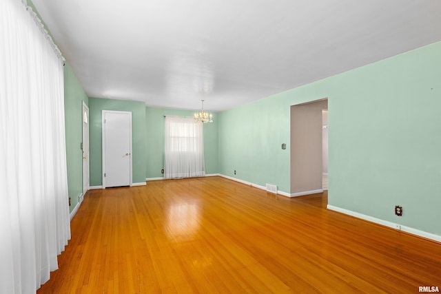 2400 W Callender Ave, West Peoria, IL 61610 - empty room with a chandelier and light wood-type flooring