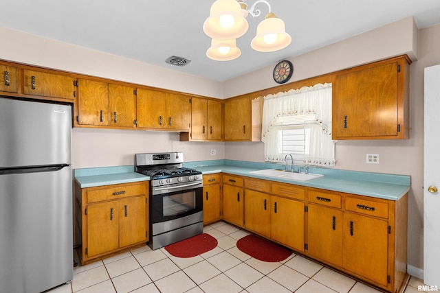 2400 W Callender Ave, West Peoria, IL 61610 - kitchen with appliances with stainless steel finishes, light countertops, and brown cabinets