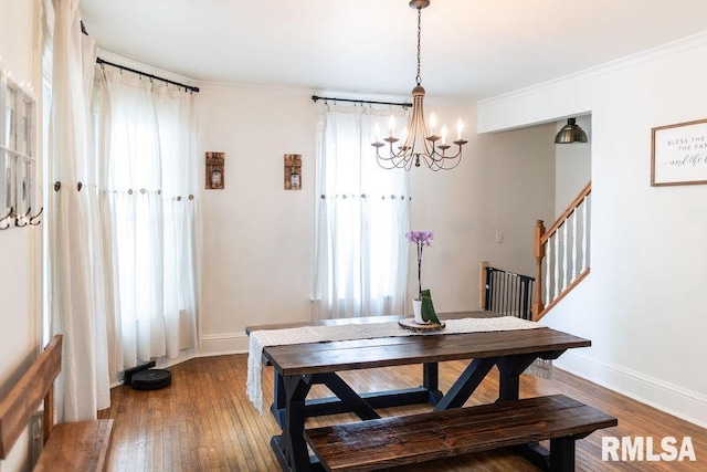306 W Fremont St, Elmwood, IL 61529 - dining area featuring a chandelier, hardwood / wood-style floors, stairway, and crown molding