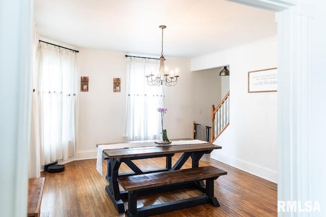306 W Fremont St, Elmwood, IL 61529 - dining room with a chandelier, stairs, wood-type flooring, and crown molding
