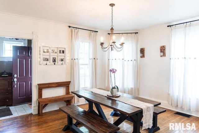 306 W Fremont St, Elmwood, IL 61529 - dining room with a chandelier, ornamental molding, and wood finished floors