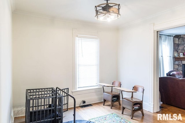 306 W Fremont St, Elmwood, IL 61529 - bedroom with wood finished floors, multiple windows, ornamental molding, and a chandelier