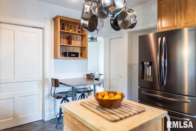 306 W Fremont St, Elmwood, IL 61529 - kitchen featuring stainless steel refrigerator with ice dispenser, open shelves, and dark tile patterned flooring
