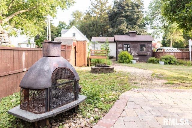 306 W Fremont St, Elmwood, IL 61529 - fenced backyard with an outdoor fire pit and an outbuilding
