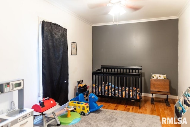 306 W Fremont St, Elmwood, IL 61529 - bedroom with ornamental molding, wood finished floors, and a ceiling fan