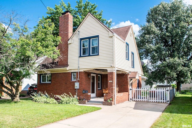1926 W Callender Ave, West Peoria, IL 61604 - view of front of house with a chimney, concrete driveway, brick siding, a porch, and roof with shingles