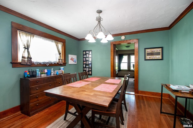 1926 W Callender Ave, West Peoria, IL 61604 - dining space with a chandelier, wood finished floors, and crown molding